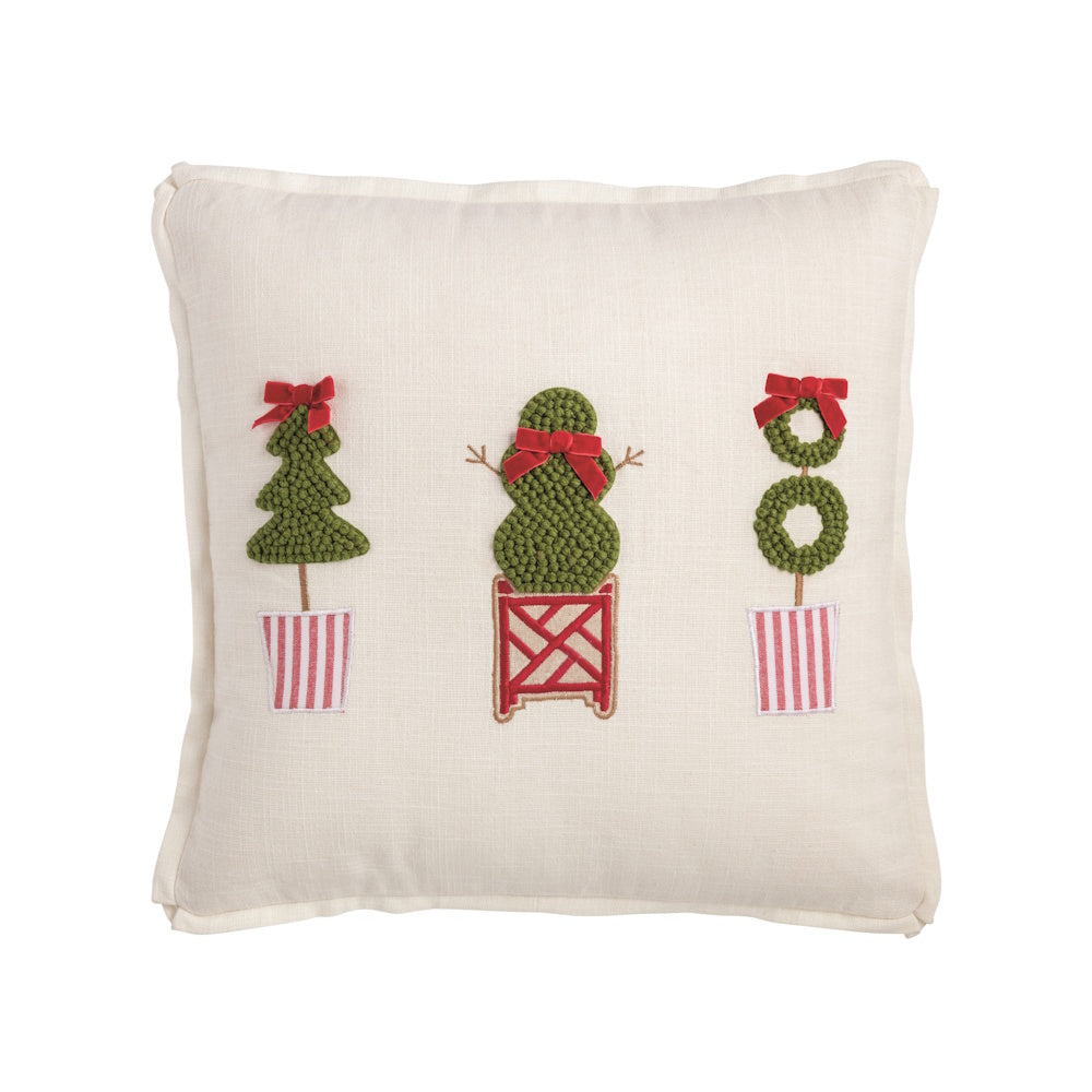 Square white Christmas pillow featuring three different green topiary tree designs with red bows.