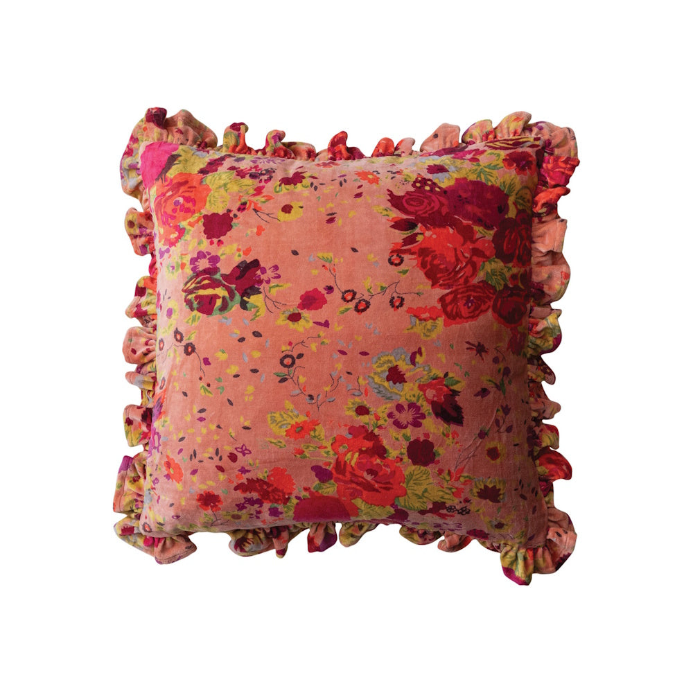 Square pink velvet pillow with a vibrant floral pattern and a ruffled border against a white background.