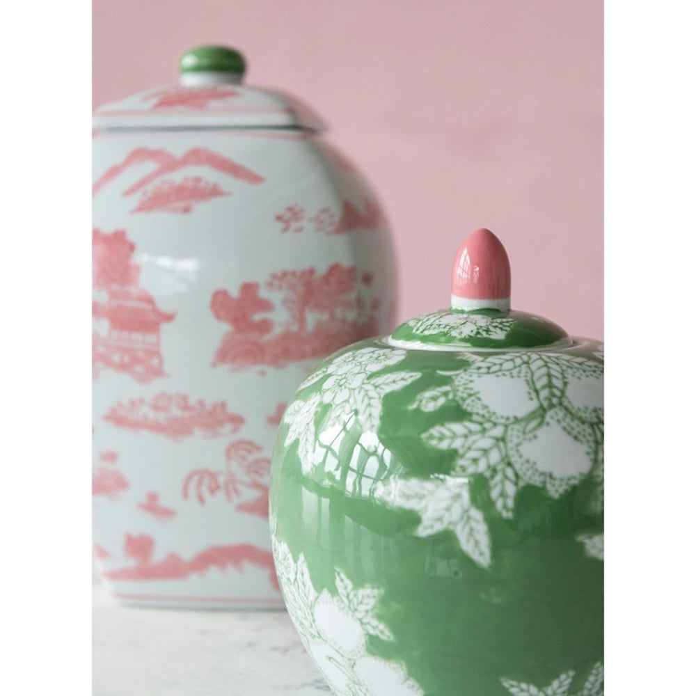 Two decorative ceramic ginger jars: one square with pink landscape art and one round with green floral patterns.