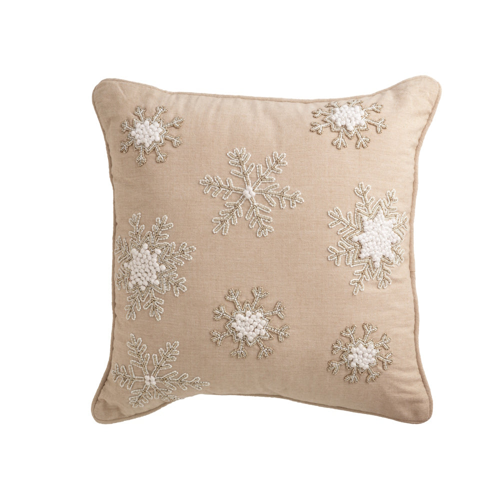 Beige square pillow featuring white and beaded snowflake patterns against a white background.