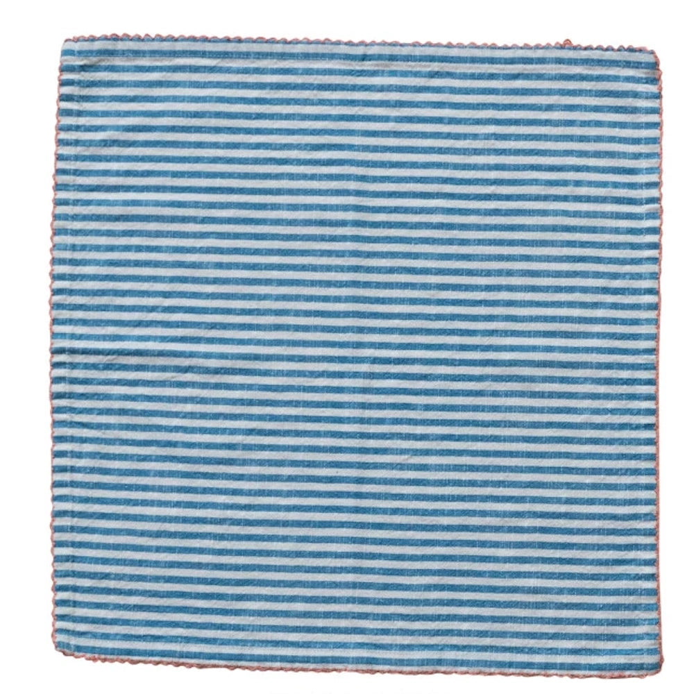 Blue and white striped linen napkin with pink scalloped embroidered edge, flat lay on white background.