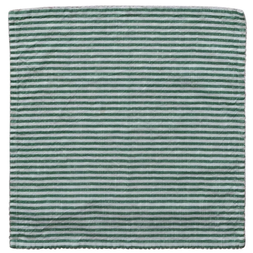 Green and white horizontal striped linen napkin with scalloped edges, flat lay on white background.