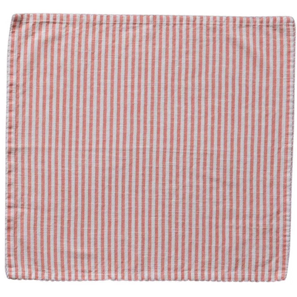 Coral and white striped cloth napkin with scalloped edges, laid flat on a white background.