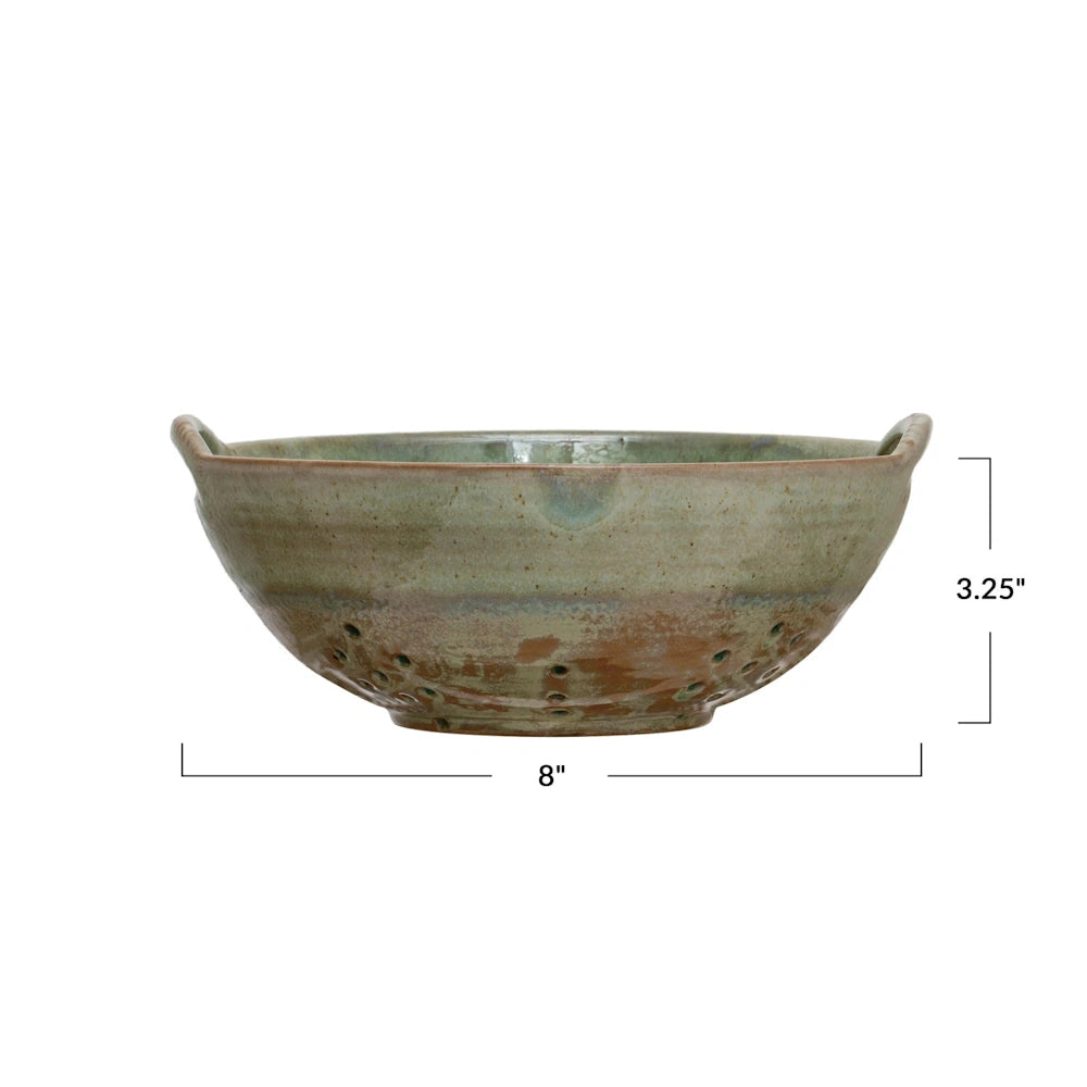 Green stoneware berry bowl colander with handles, 8 inches wide and 3.25 inches tall.