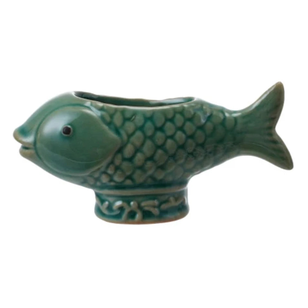 Small green fish-shaped ceramic pottery bowl with scale texture and pedestal base.