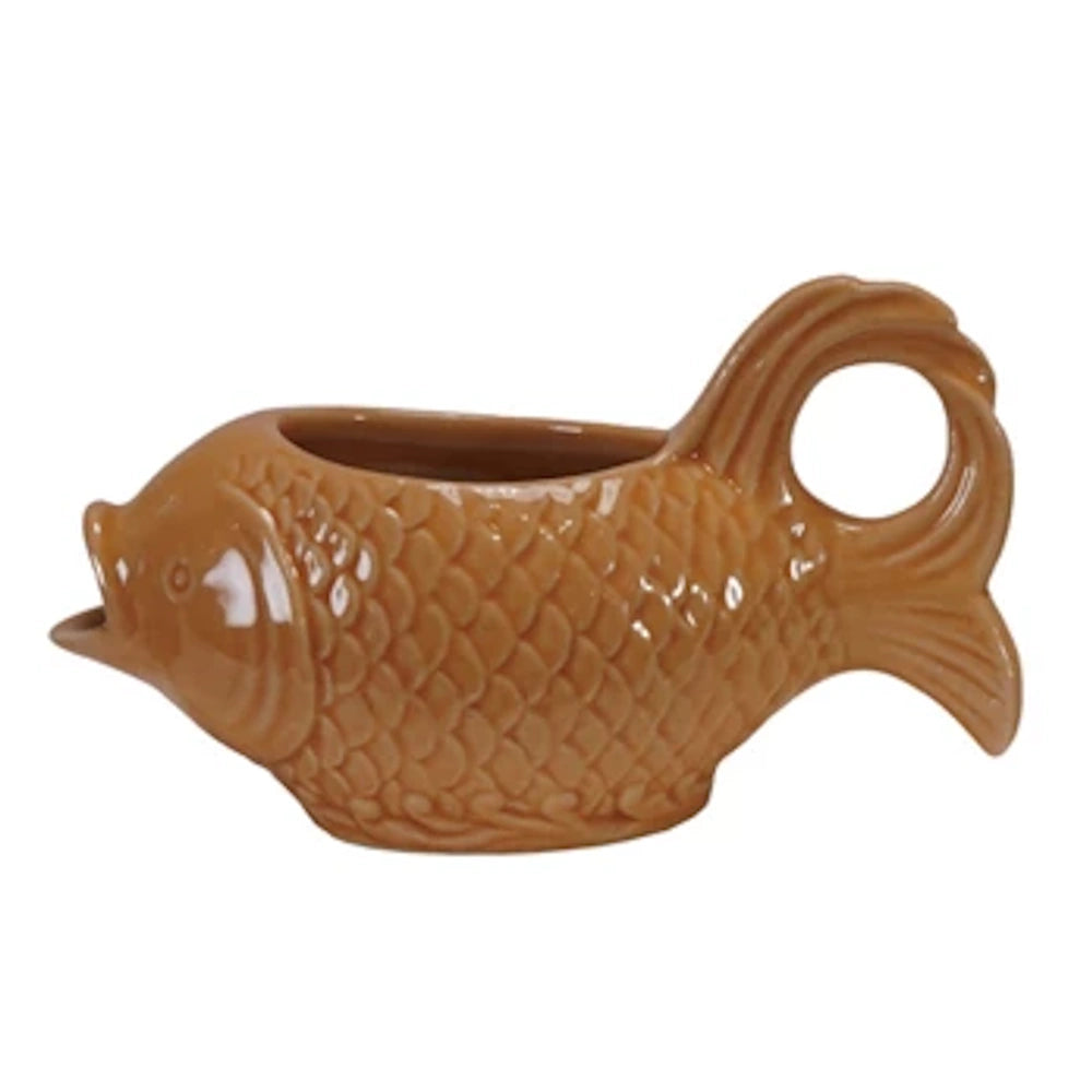 Vintage style orange fish gravy boat or creamer, ceramic nautical kitchenware, side view.