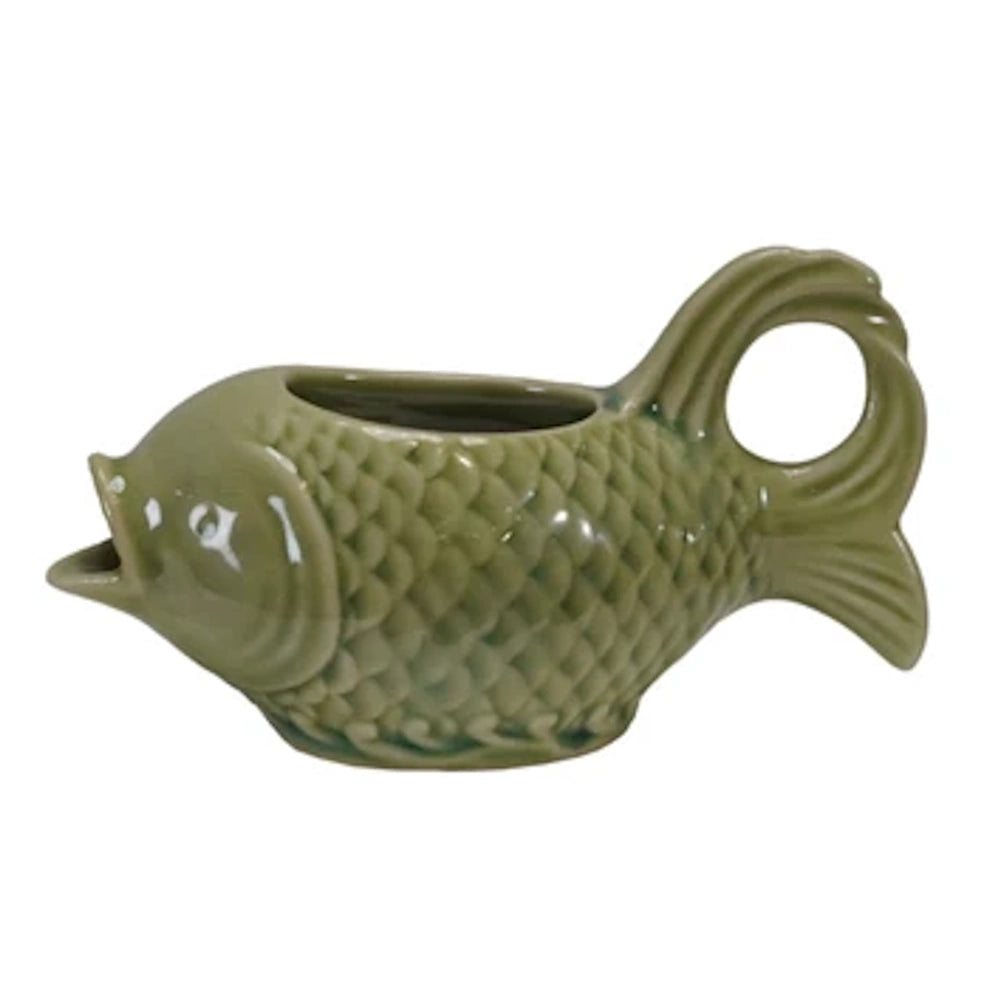 Green ceramic fish-shaped cream pitcher with scale texture and open mouth pour spout.