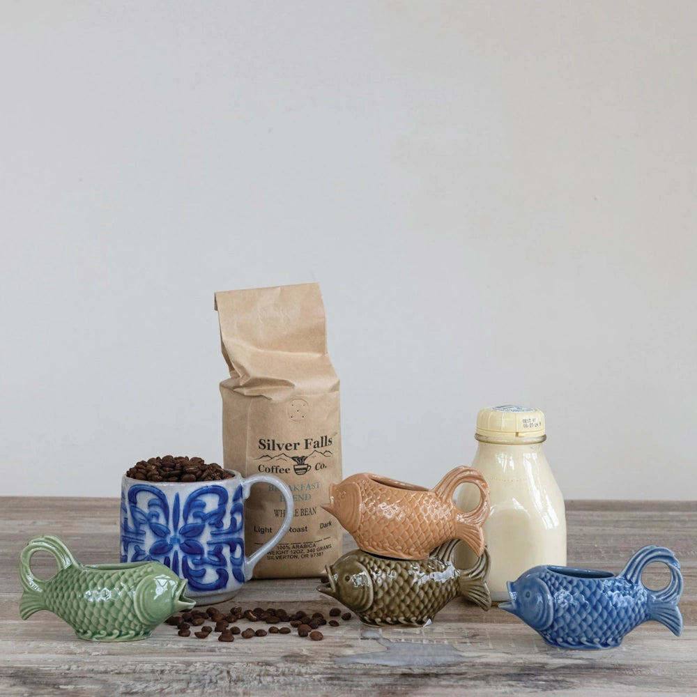 Silver Falls Coffee breakfast blend beans with colorful fish-shaped ceramic creamers and a fresh milk bottle.
