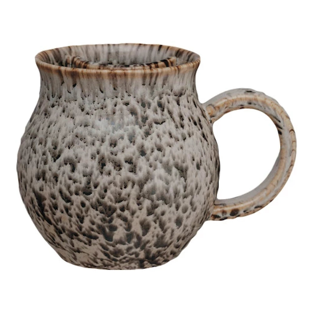 Handcrafted speckled ceramic coffee mug with brown and cream glaze and ergonomic handle on white background.