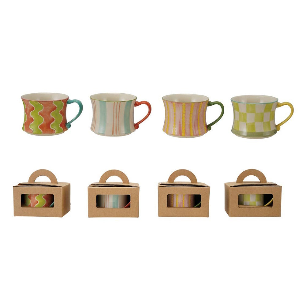 Four colorful pattern-painted stoneware mugs displayed alongside individual kraft gift boxes.
