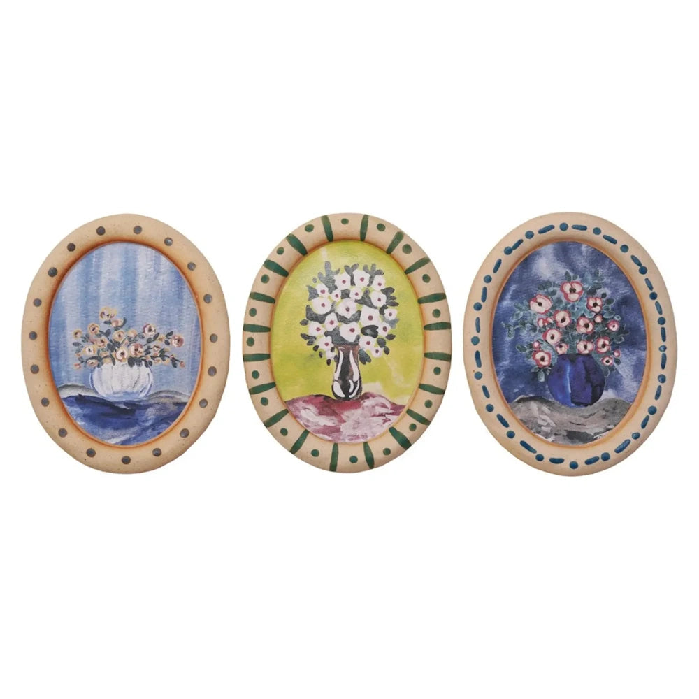 Set of 3 vintage-style oval framed floral paintings, watercolor flower bouquets in vases on colorful backgrounds.