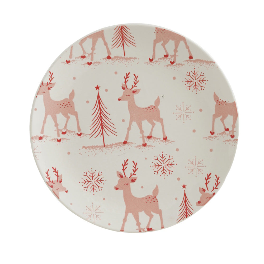 Stoneware plate featuring a red holiday pattern of reindeer, trees, and snowflakes on a white background.