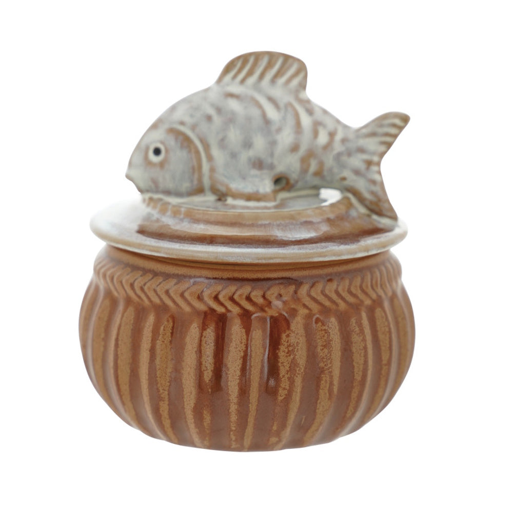 Brown stoneware salt cellar with a decorative fish lid and textured, ribbed base on a white background.