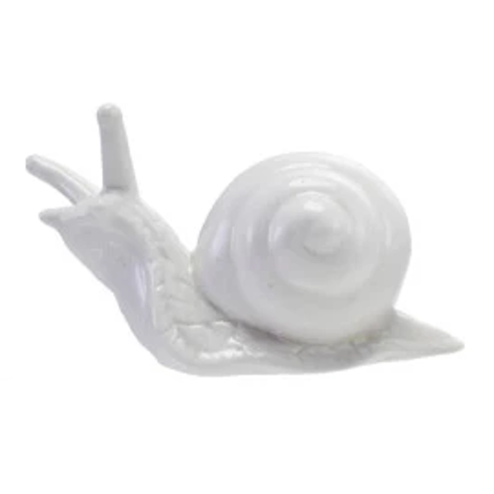 A simple white ceramic snail figurine with a glossy finish, facing left, on a plain white background.