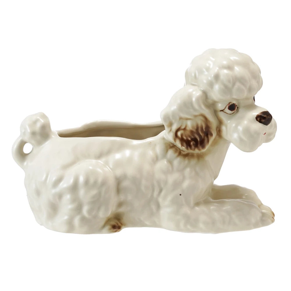 Vintage-style white ceramic poodle planter with hand-painted brown details on a white background.