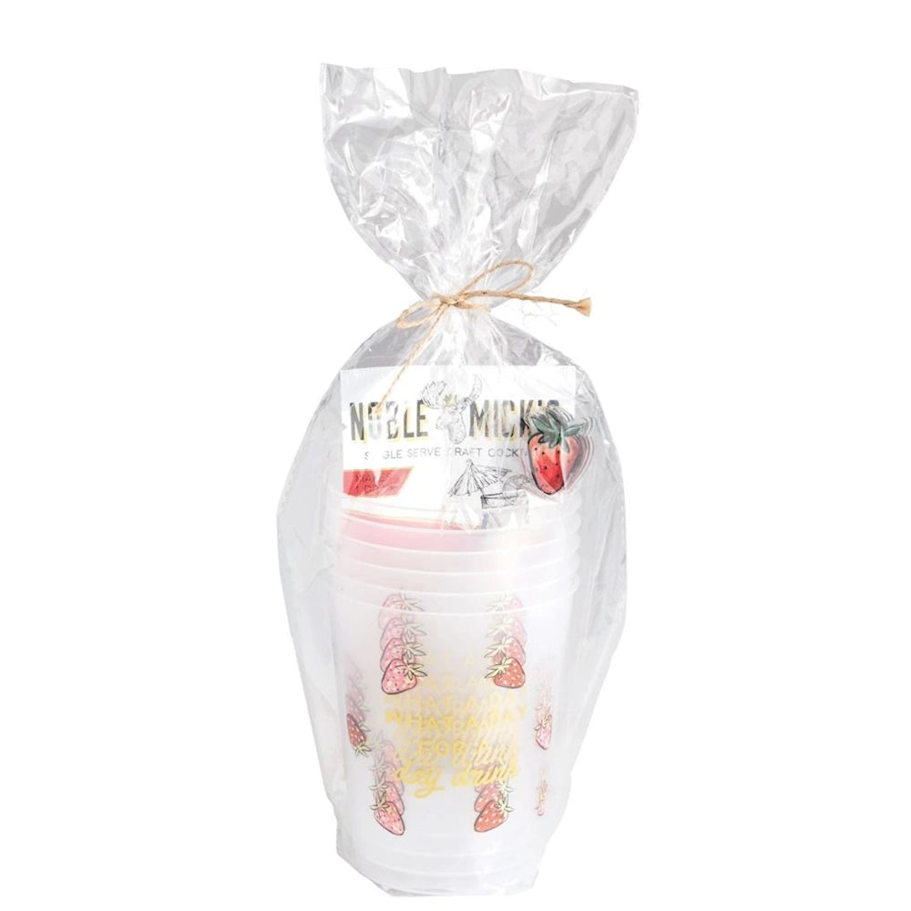 A stack of plastic cups with strawberry illustrations, wrapped in clear cellophane and tied with twine.