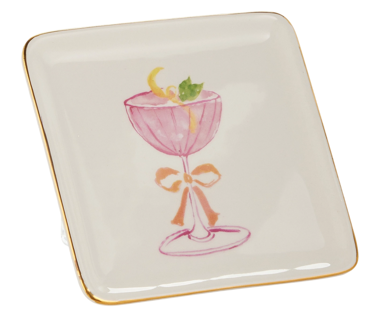 Square ceramic plate with gold trim, featuring a pink cocktail glass with a lemon twist and mint garnish, accented by a bow, conveying elegance.