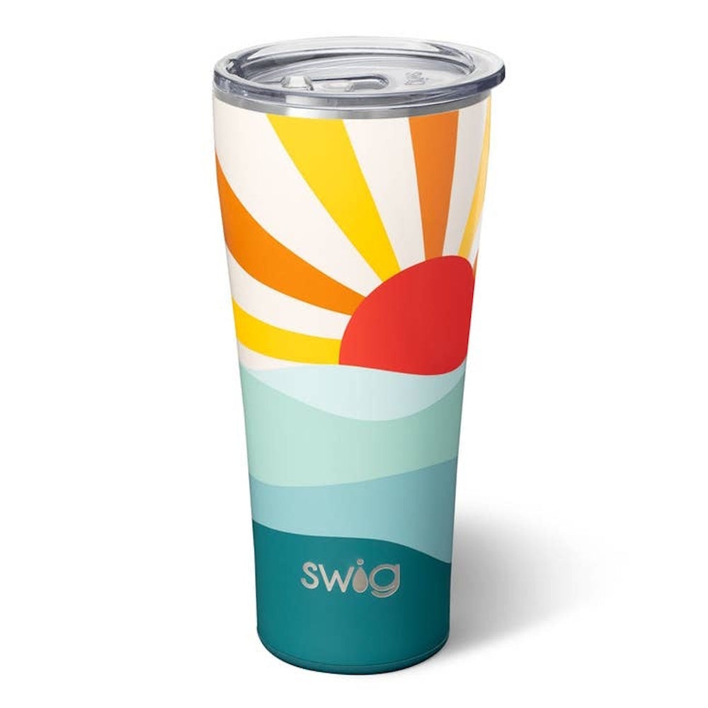 A Swig travel tumbler with a retro sunburst design over layered teal and blue waves, featuring a clear lid.