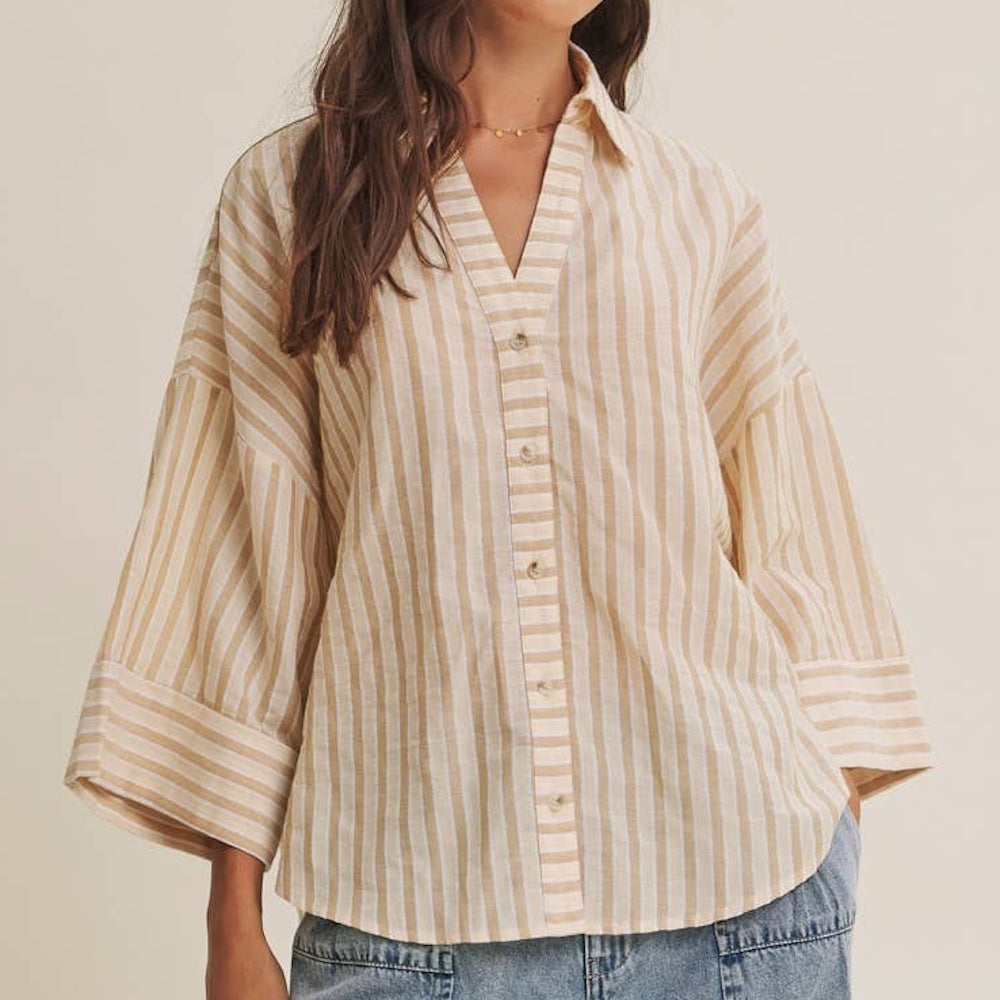 Relaxed beige and white striped button-down shirt featuring wide sleeves and a V-neckline.