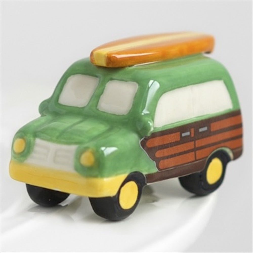 Ceramic miniature green woody station wagon with a surfboard on top.