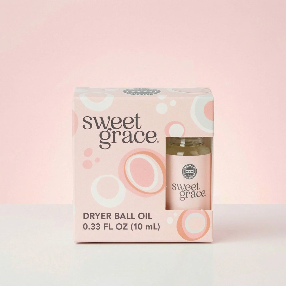 Box of Sweet Grace dryer ball oil displaying a small bottle through a cutout window.
