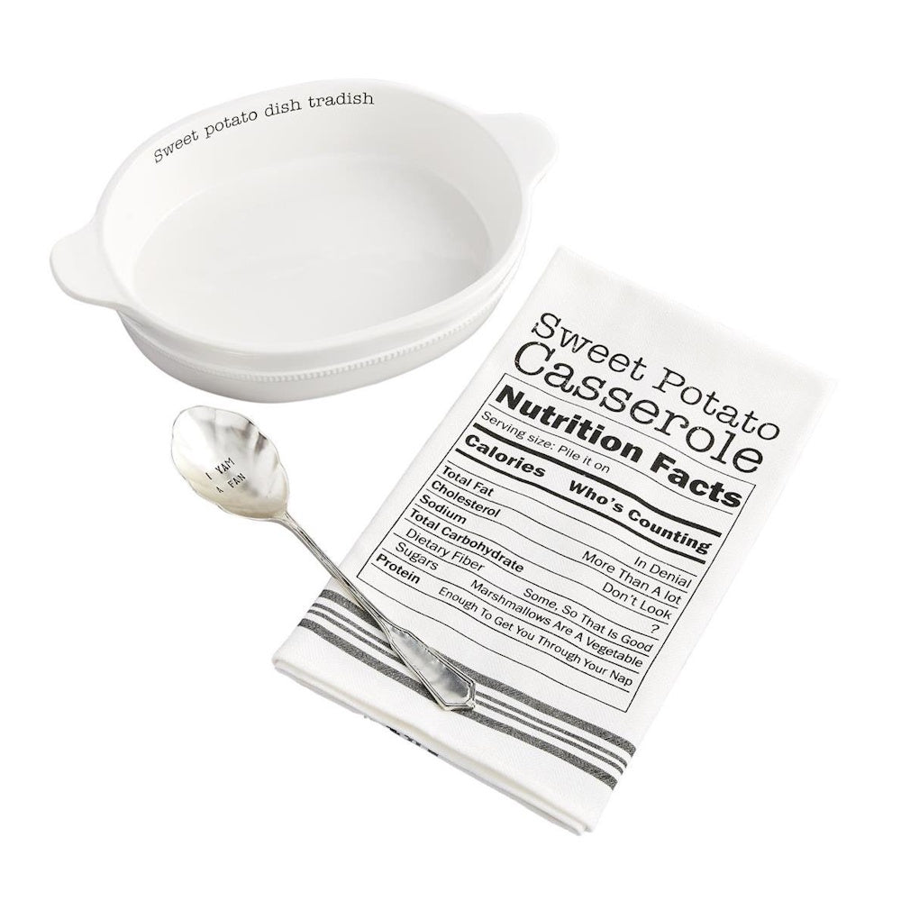 White ceramic baker, stamped silver spoon, and kitchen towel with Sweet Potato Casserole facts.