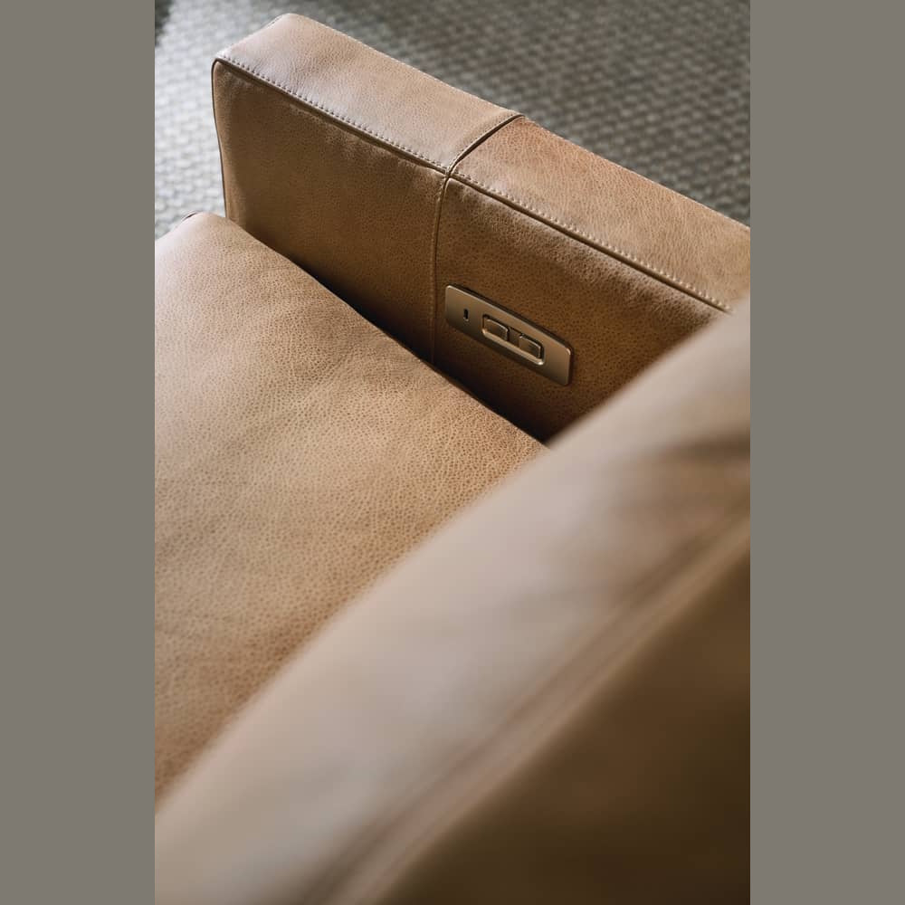 Close-up of a Sylvie tan leather power recliner showing the side control buttons and pebbled texture.