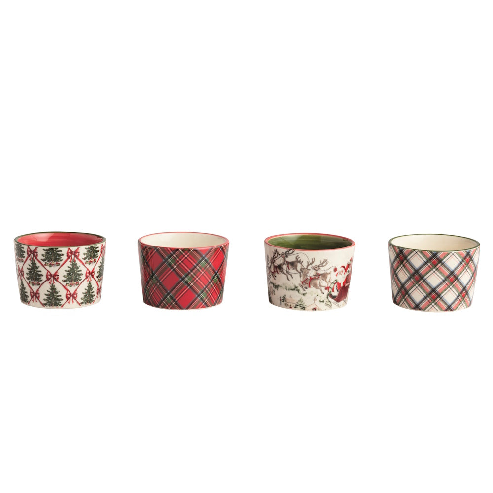 Front view of a set of four multicolored ceramic Christmas tidbit dishes with assorted holiday patterns.