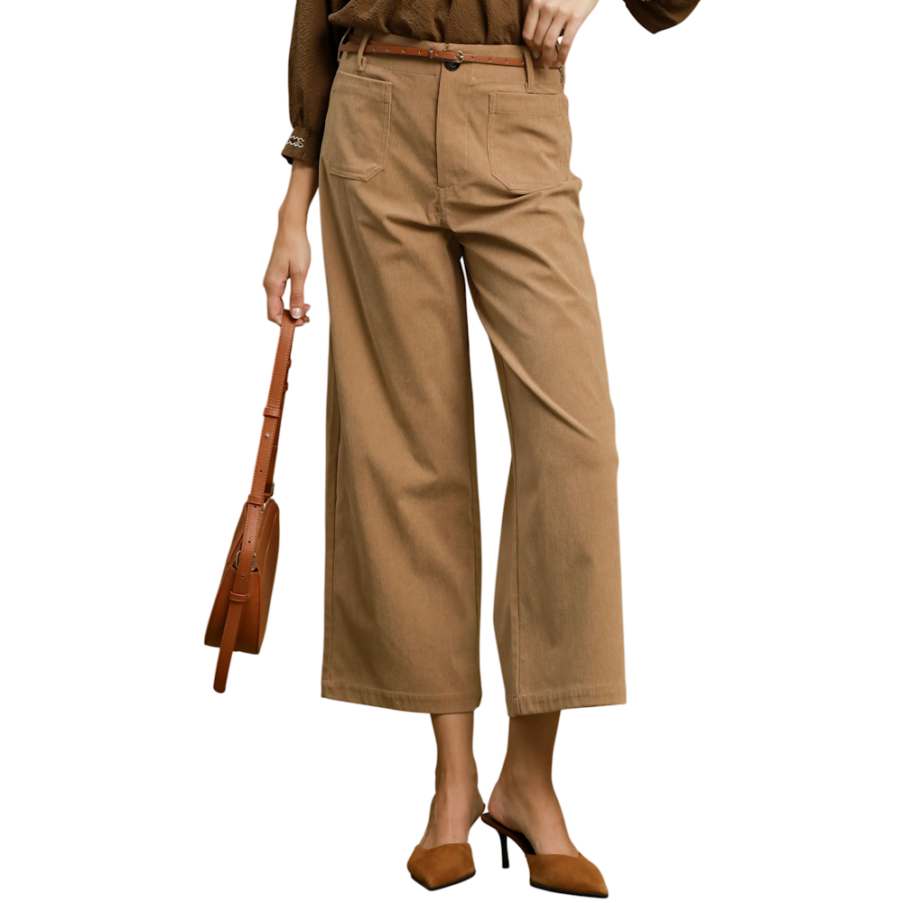 Woman wearing taupe wide-leg corduroy pants with front pockets, paired with a skinny belt and brown heels.