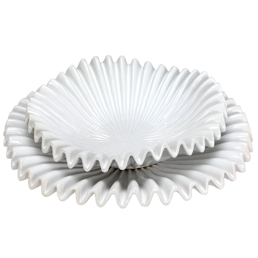Two stacked white ceramic bowls with a distinctive wavy, ruffled edge and a glossy finish against a white background.