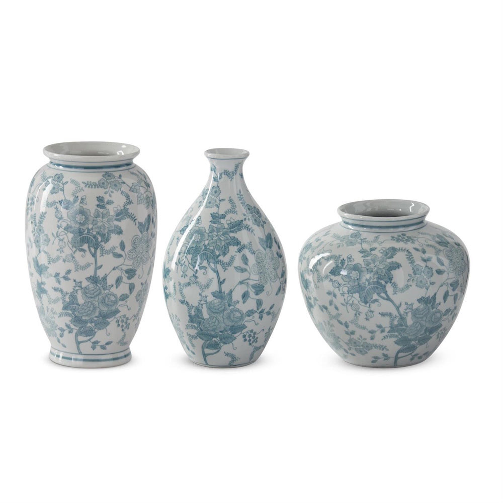 Teal and white porcelain Chinoiserie vases with floral patterns in three assorted shapes on a white background.