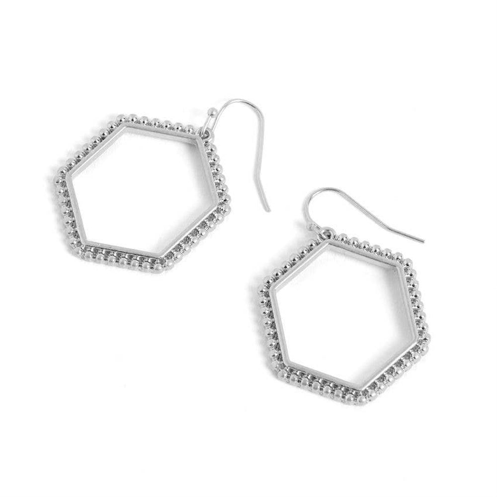 Pair of silver open hexagon dangle earrings with a textured beaded border on a white background.