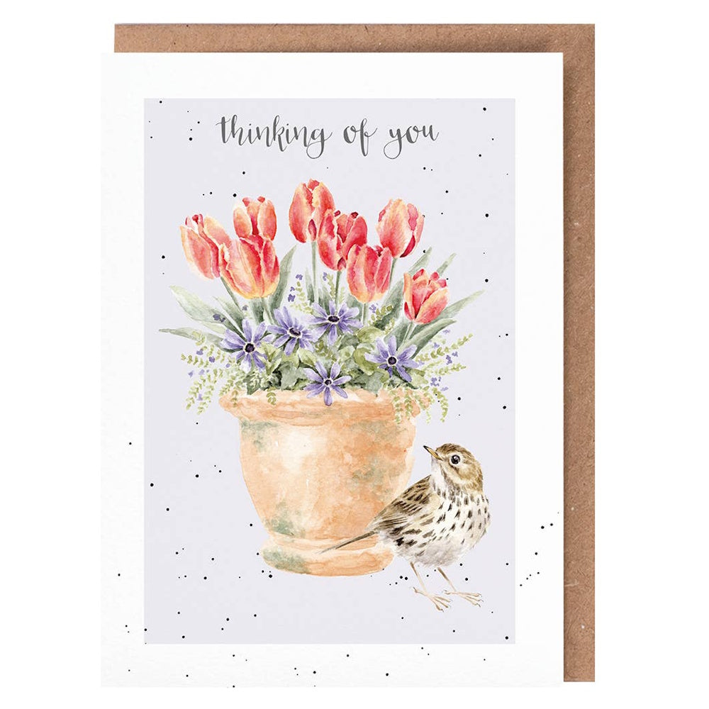 Watercolor meadow pipit bird standing next to a flowerpot of red tulips and purple blooms with Thinking of You text.