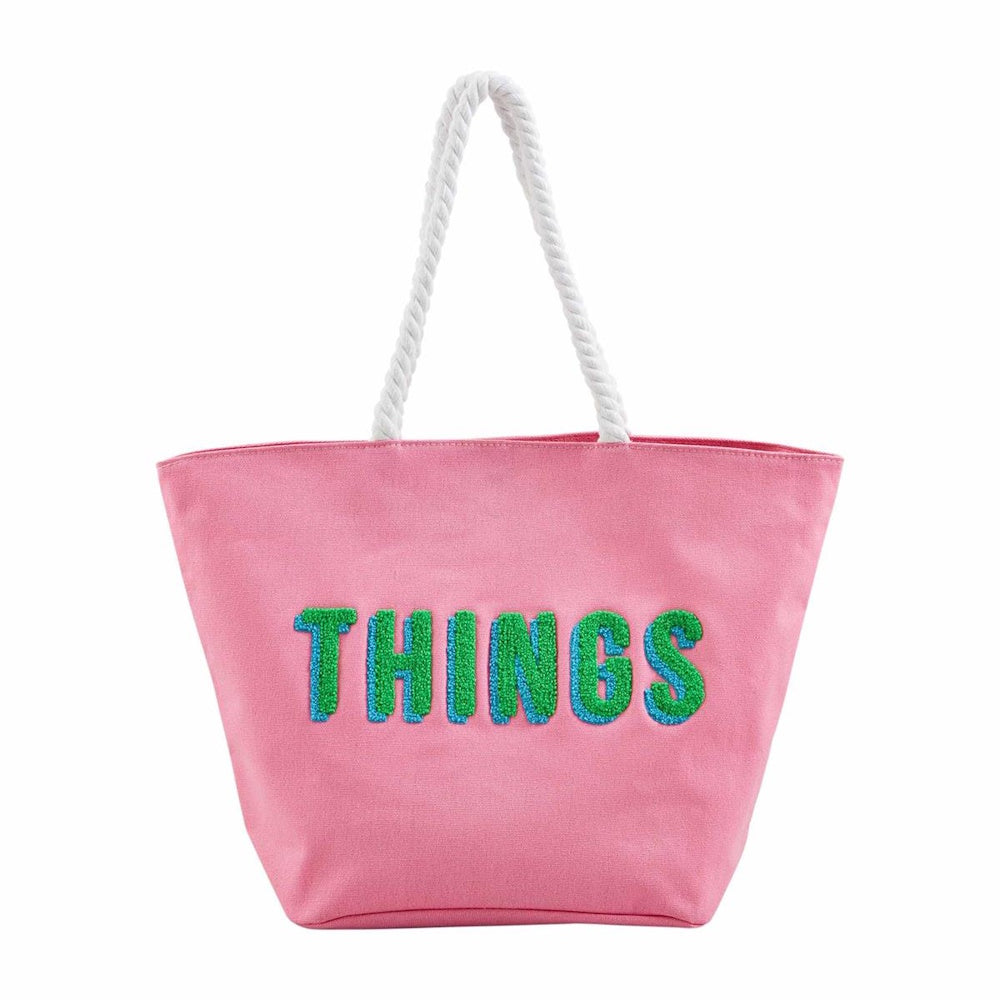 Pink canvas tote bag with white rope handles and the word "THINGS" in green and blue textured lettering.
