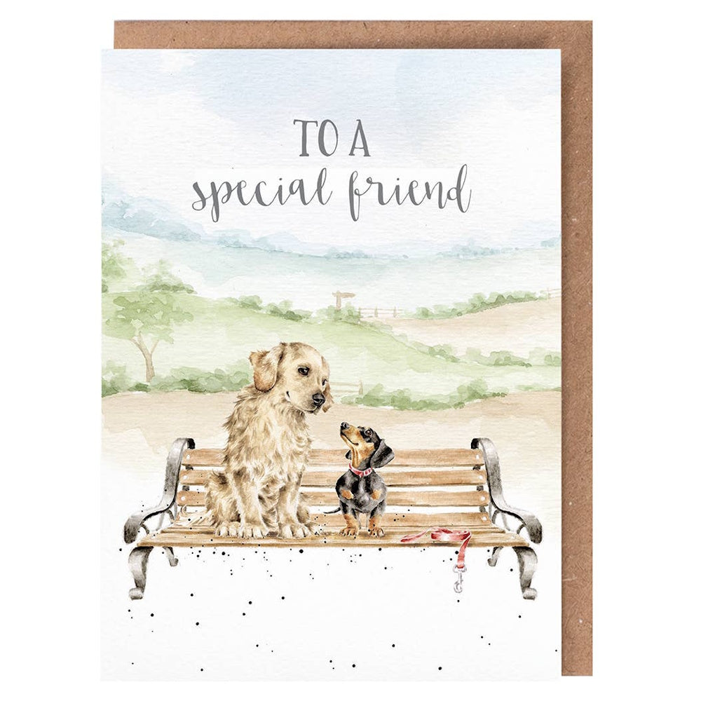 Watercolor illustration of a golden retriever and dachshund on a park bench with "To a special friend" text.