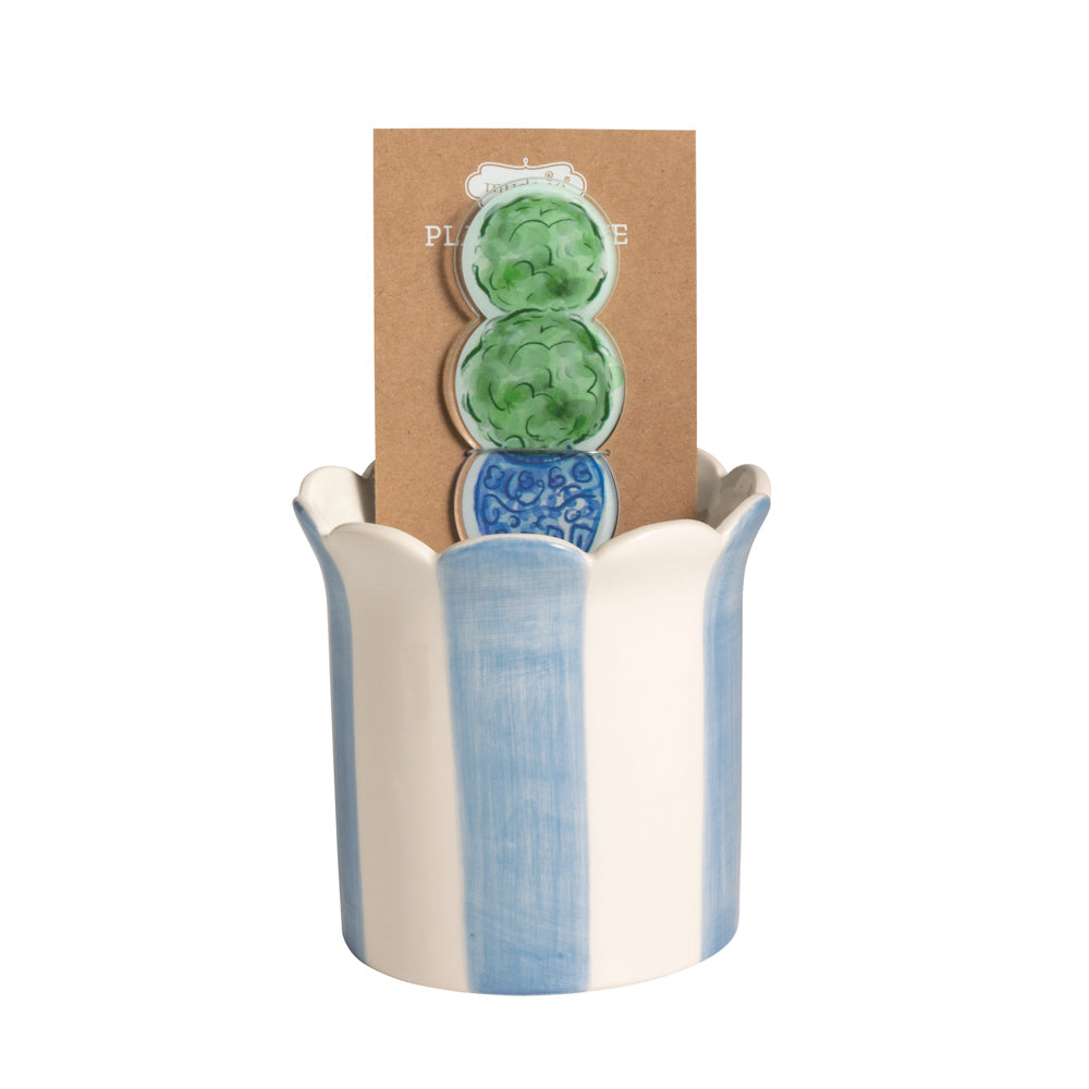 Blue and white striped ceramic scalloped pot with a green topiary plant stake on a brown card.