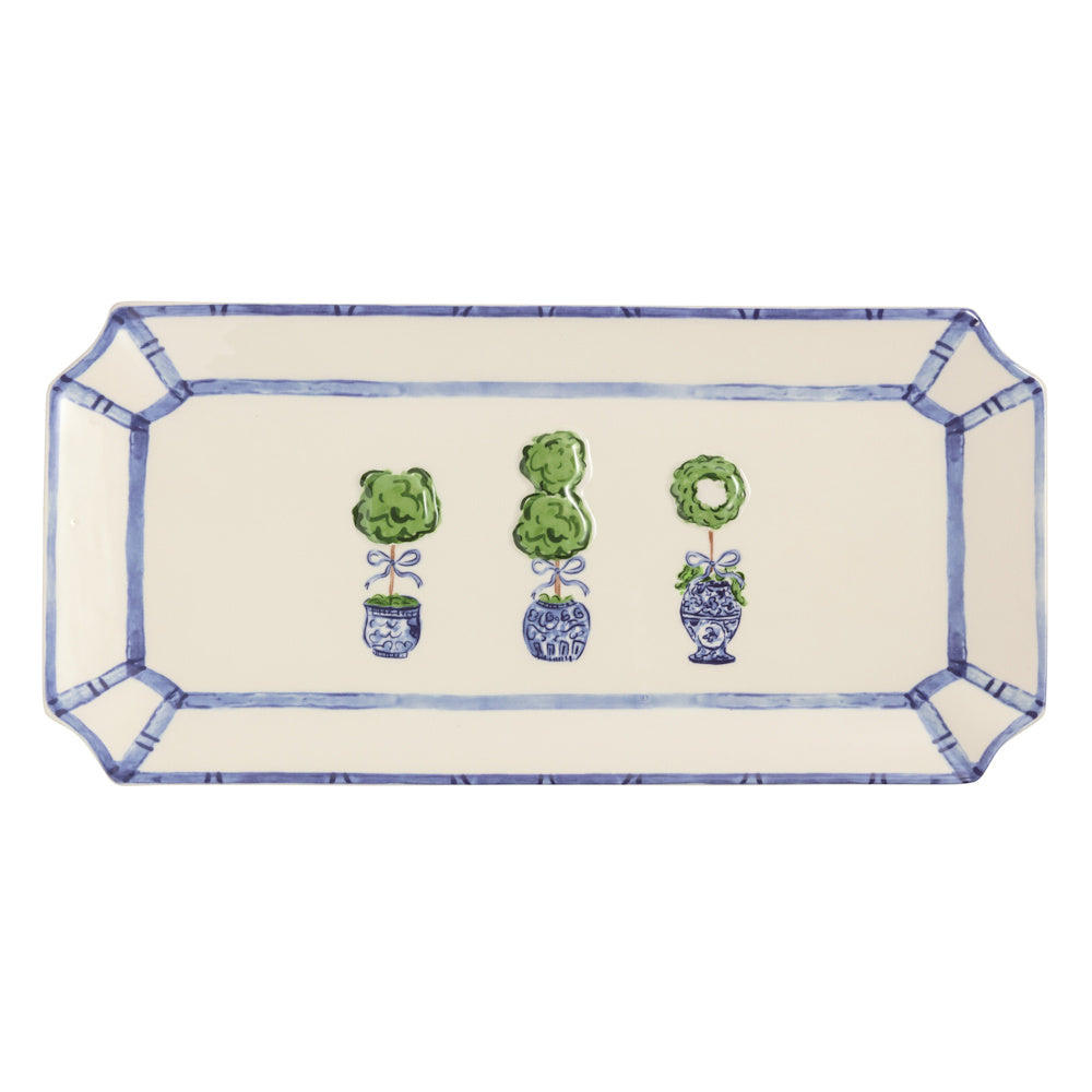 Rectangular ceramic tray featuring three green topiaries in blue and white chinoiserie pots with a blue bamboo border.