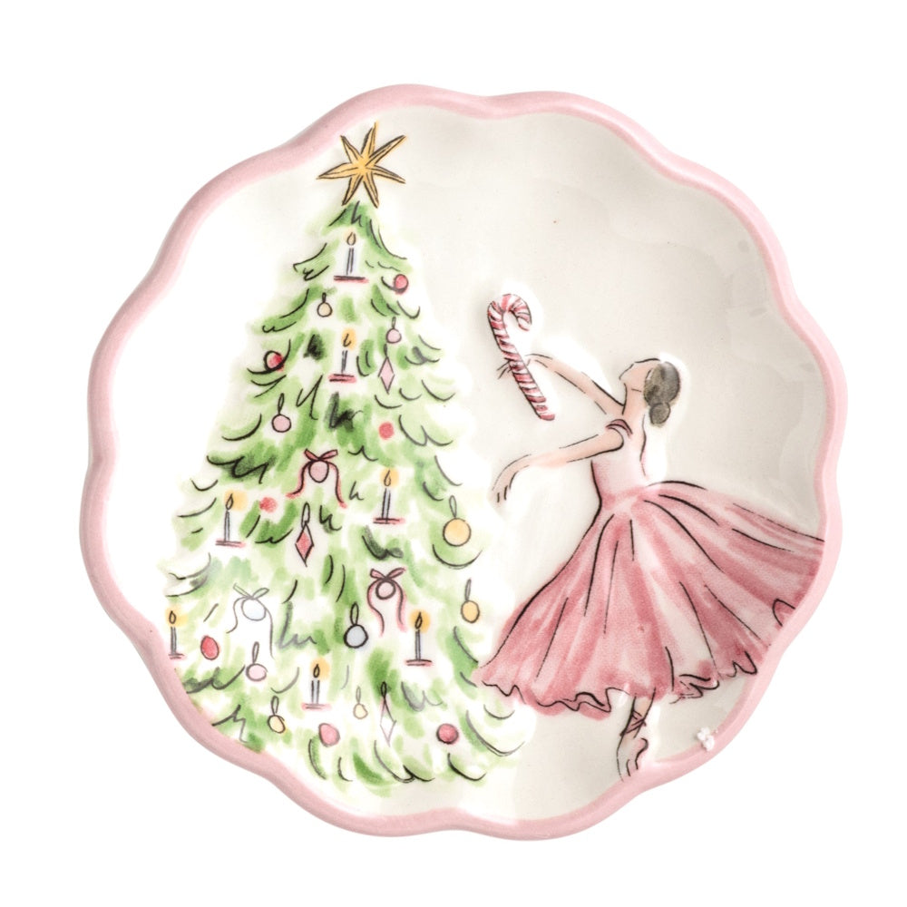 Scalloped white tidbit plate featuring a ballerina dancing next to a decorated Christmas tree with a pink border.