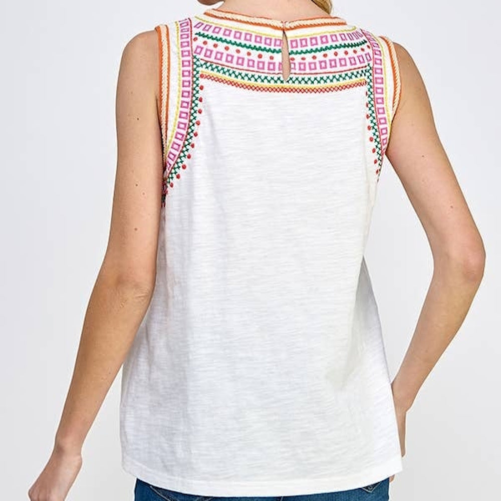 Back view of a white sleeveless top featuring colorful geometric embroidery around the neckline and shoulders.