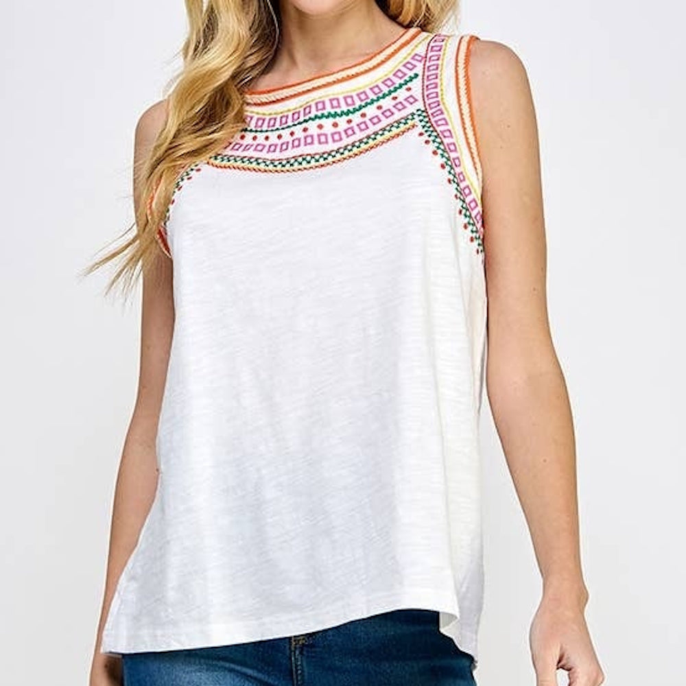 White sleeveless top with colorful geometric embroidery around the neckline and armholes.