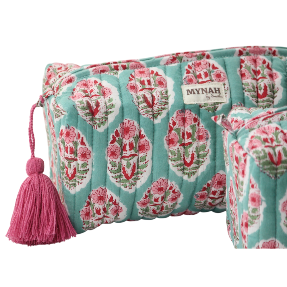 Quilted turquoise block print zipper pouch with pink floral motif, fabric tassel, and MYNAH brand label.