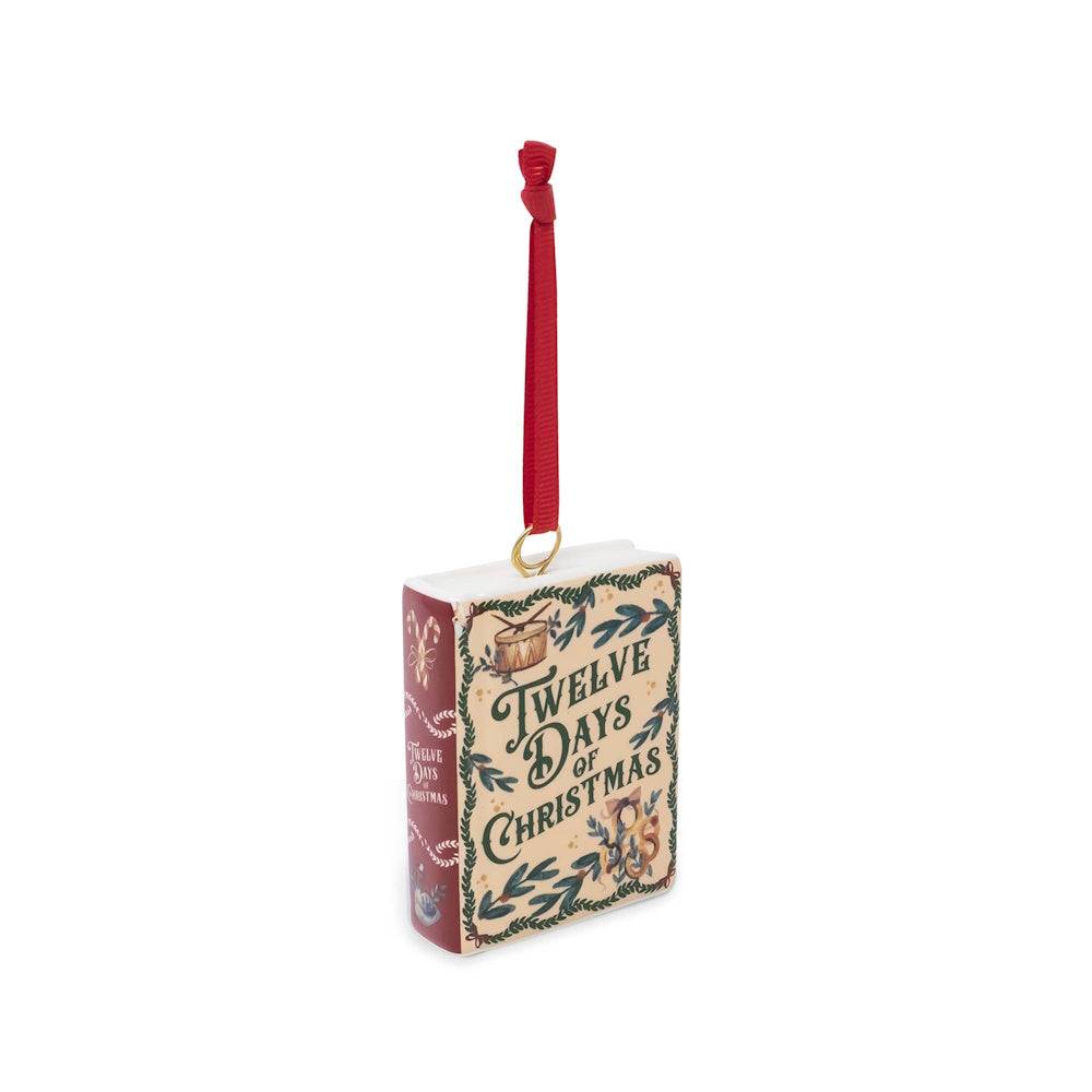 Ceramic book-shaped ornament featuring "Twelve Days of Christmas" cover art and a red hanging ribbon.
