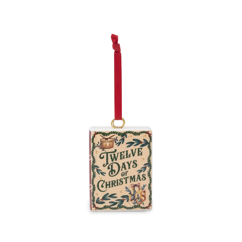 Book-shaped ceramic ornament reading "Twelve Days of Christmas" with festive foliage details and a red hanging ribbon.