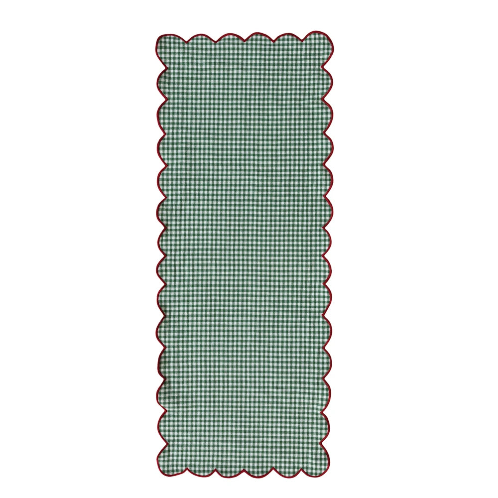 Green and white gingham checkered table runner featuring red scalloped trim.