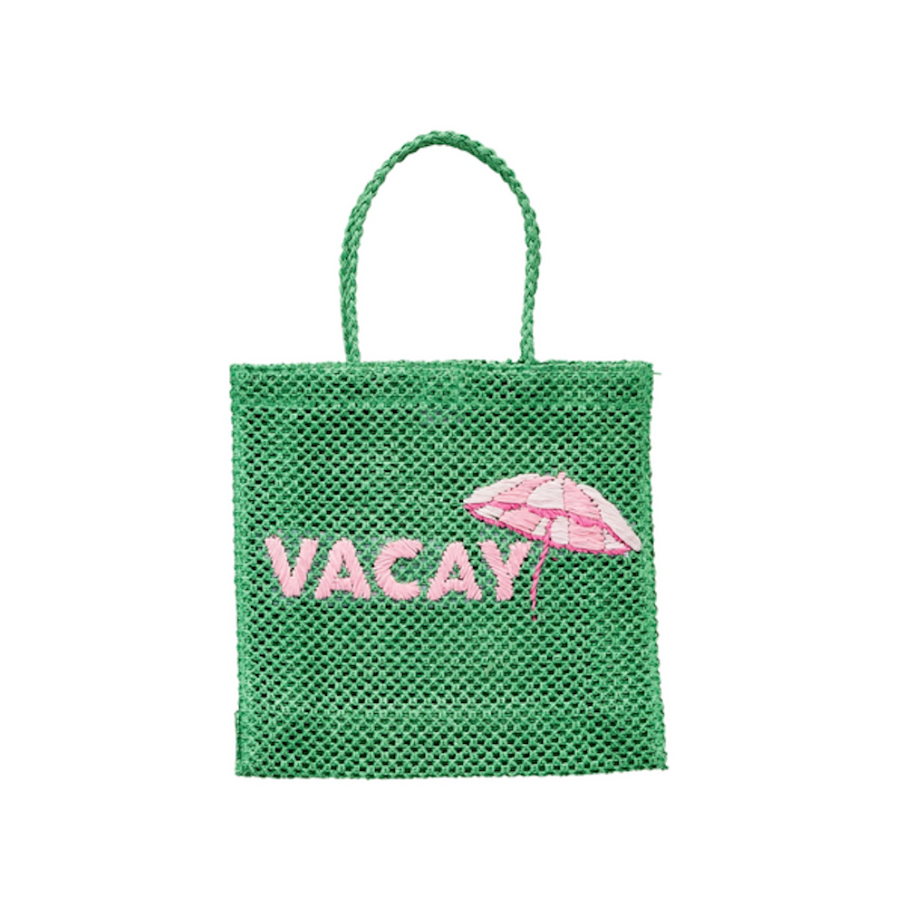 Green woven mesh tote bag with a top handle, featuring the pink embroidered word "VACAY" and a beach umbrella.