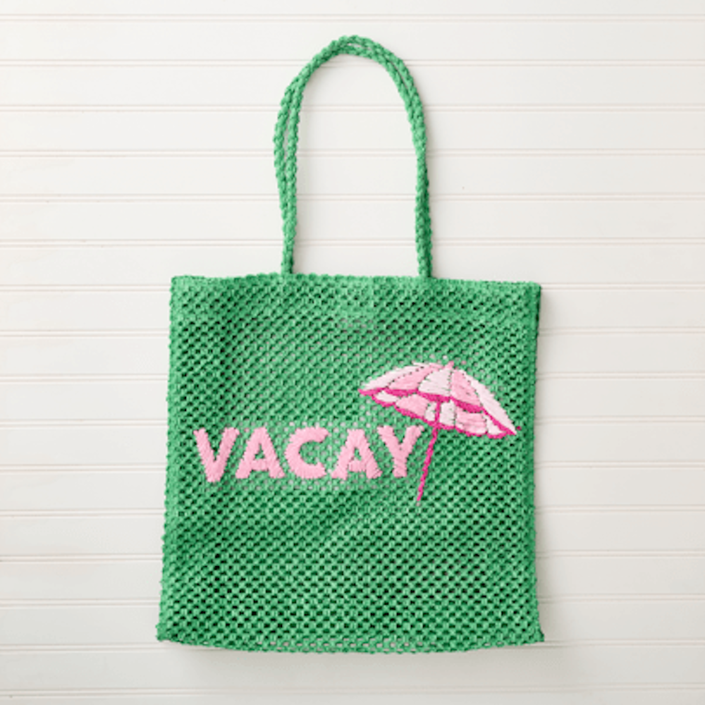 Green woven mesh tote bag featuring pink embroidered "VACAY" text and a matching pink beach umbrella design.