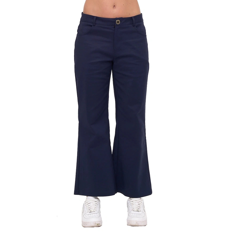 Navy wide-leg ankle pants with a button fly and front pockets, styled with white sneakers on a white background.