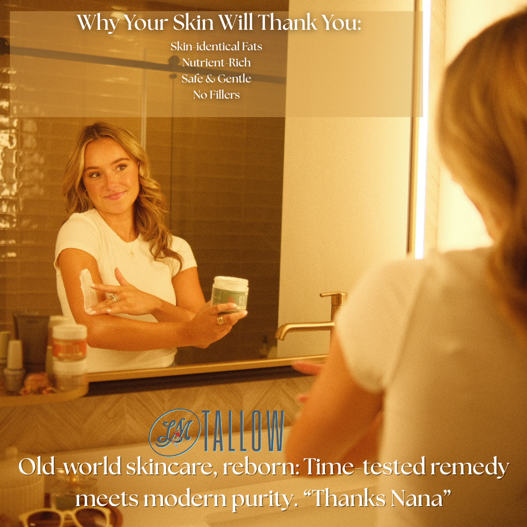 A woman applies whipped vanilla tallow moisturizer to her arm in a bathroom mirror.