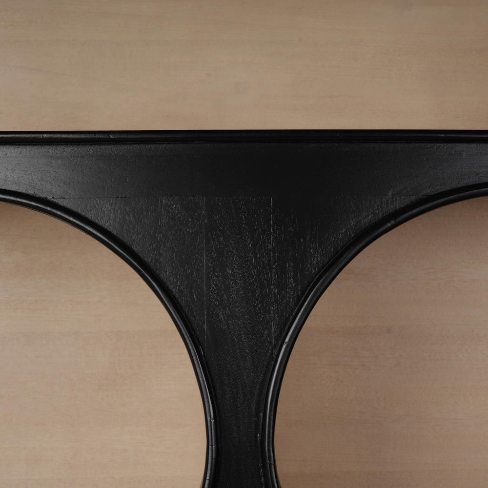 Close-up of a modern black wooden crescent bookcase shelf arch detail.