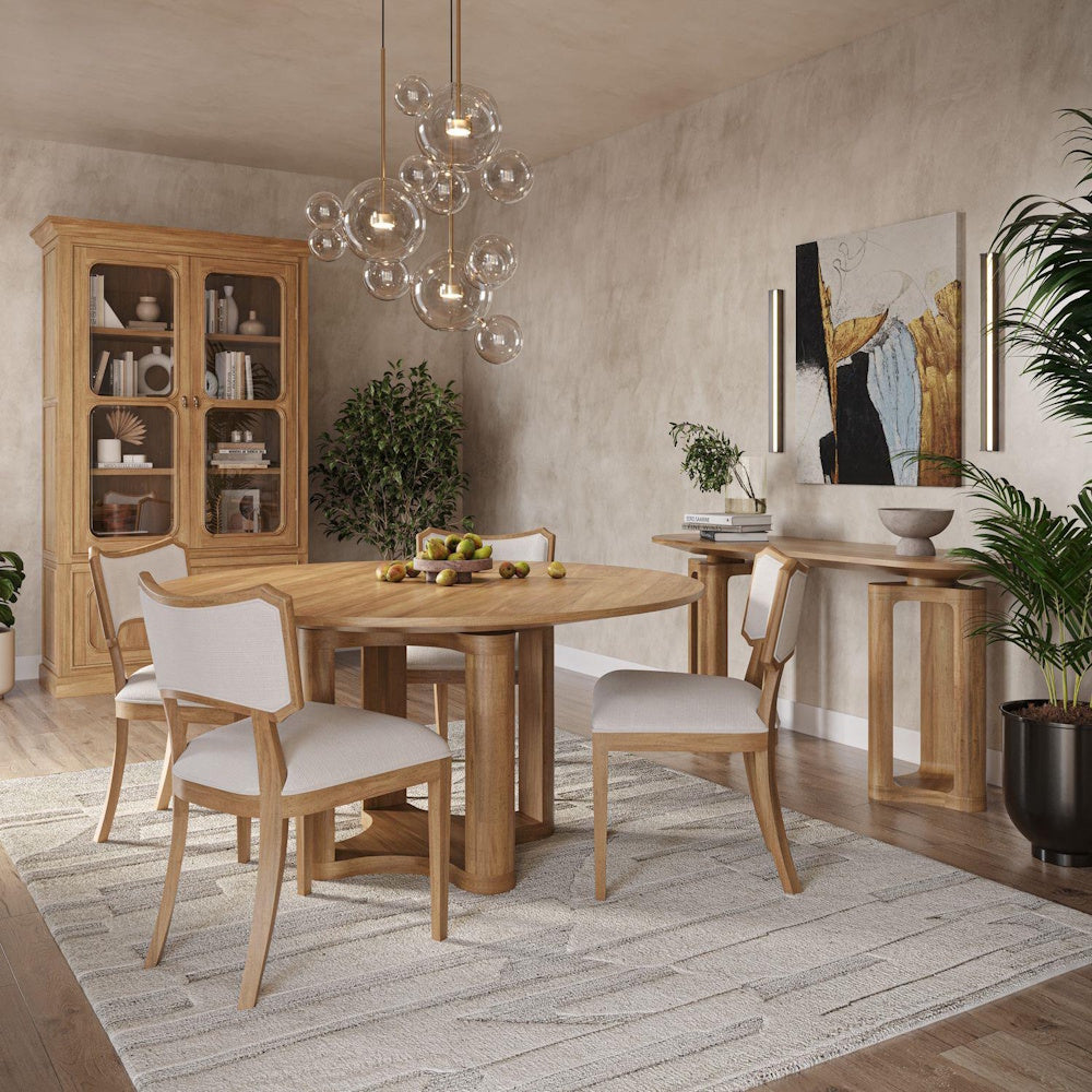 Modern round wooden dining table and chairs in a textured dining room next to a Victoria oak glass bookcase.